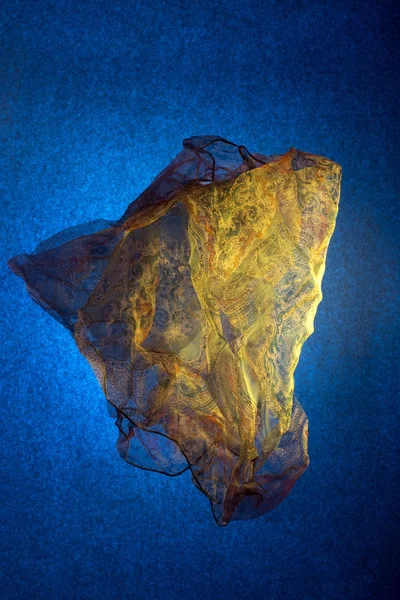 Transparent thin handkerchief on a blue background