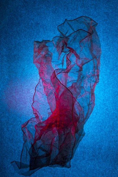 Transparent thin handkerchief on a blue background