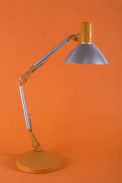 Table lamp for desktop on an orange background