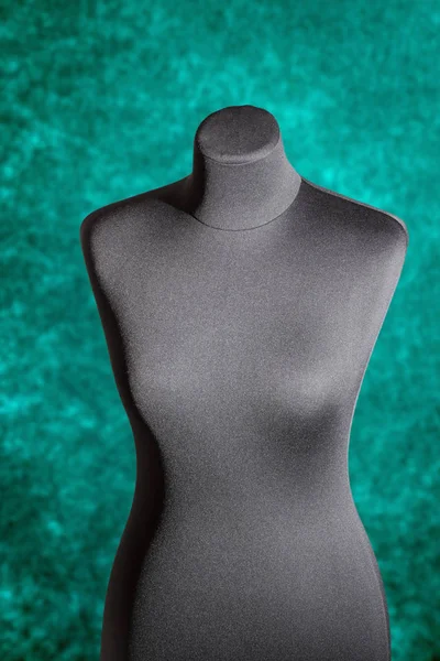 Mannequin female trunk on a green background