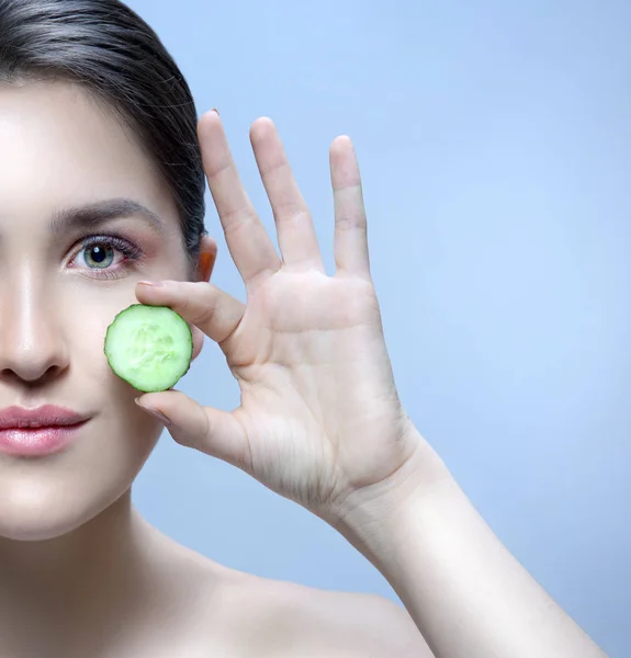 woman beauty face with cucumber