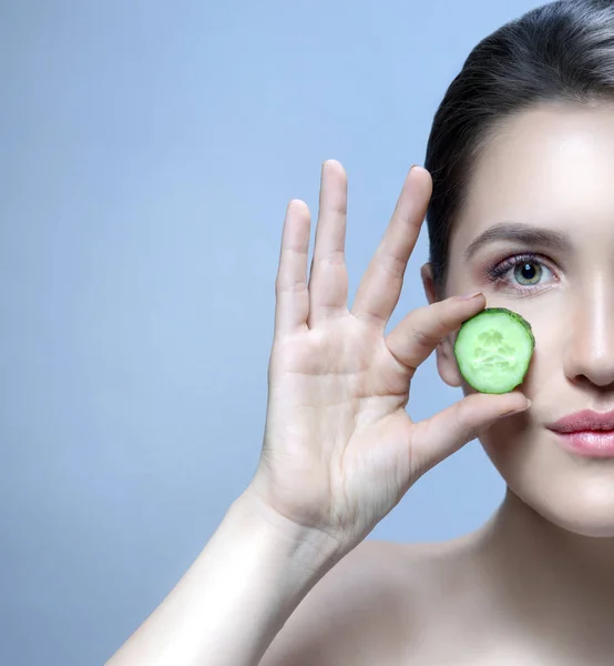 woman beauty face with cucumber