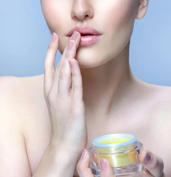 beautiful woman applying face cream