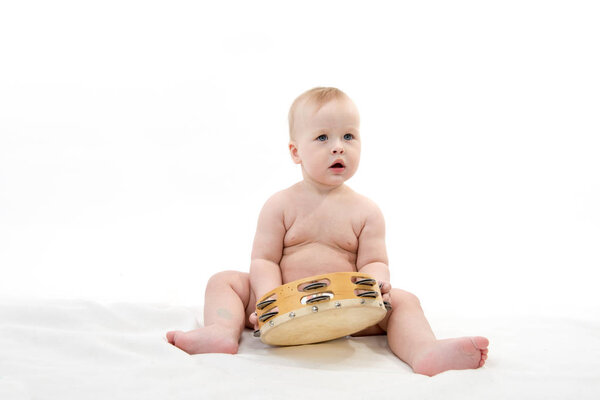 little child baby playing music isolated on white studio shot