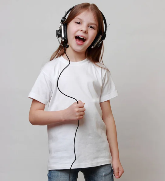 Fashion little girl with headphone singing