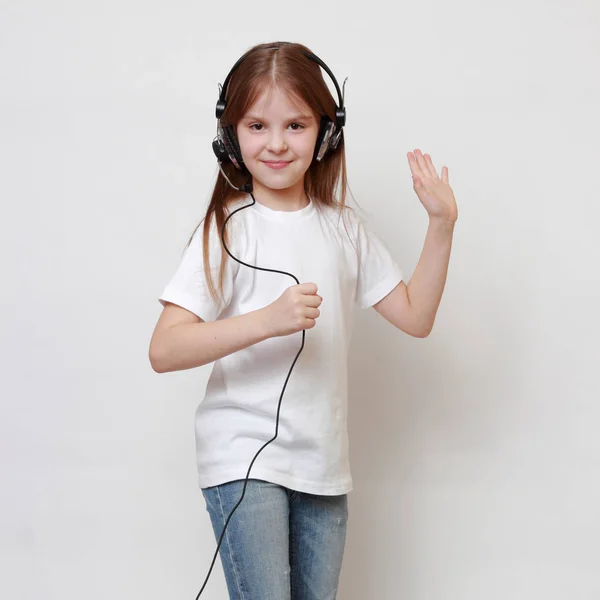 Fashion little girl with headphone singing