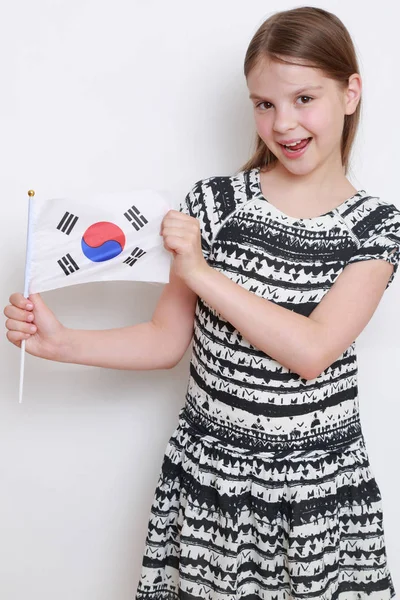 Beautiful little girl and Japanese flag (flag of Japan)