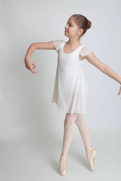 Beautiful little ballerina on pointe  in studio