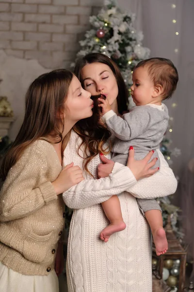 休日のテーマのクリスマス ツリーを娘と赤ちゃんの男の子を持つ母 — ストック写真