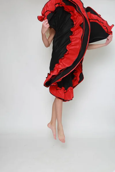 Studio image of flamenco dancer is jumping/Dancer in motion