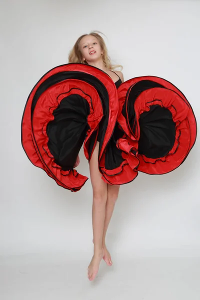 Studio image of flamenco dancer is jumping/Dancer in motion