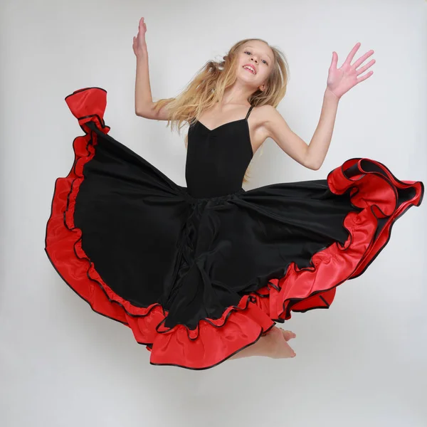 Studio image of flamenco dancer is jumping/Dancer in motion