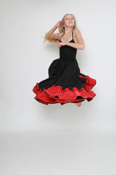 Studio image of flamenco dancer is jumping/Dancer in motion