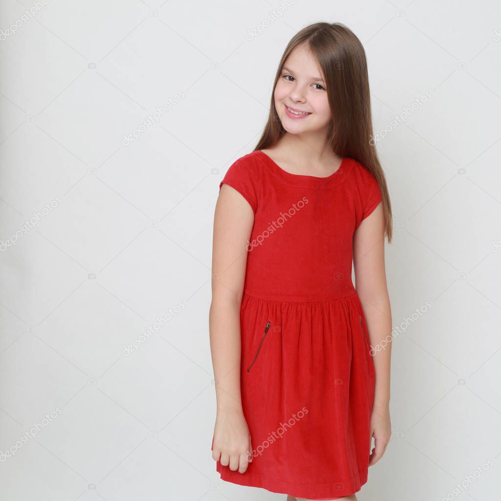 Emotional little girl wearing red dress