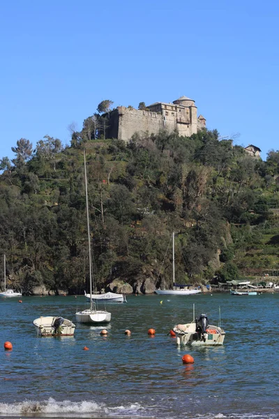 Portofino, İtalya - 5 Nisan 2018: Lüks İtalyan tatiller - güzel Portofino Ligurian kıyısında. Mavi su ve misafir Portofino, köy taç aracılığıyla koy görünümü.