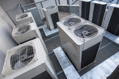 Air conditioning equipment atop a modern building - aerial/drone clipart