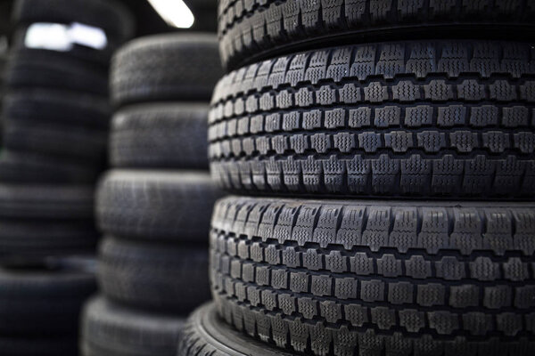 Tires for sale at a tire store - stacks of old used tires