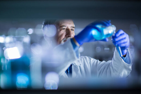 Senior male researcher carrying out scientific research in a lab