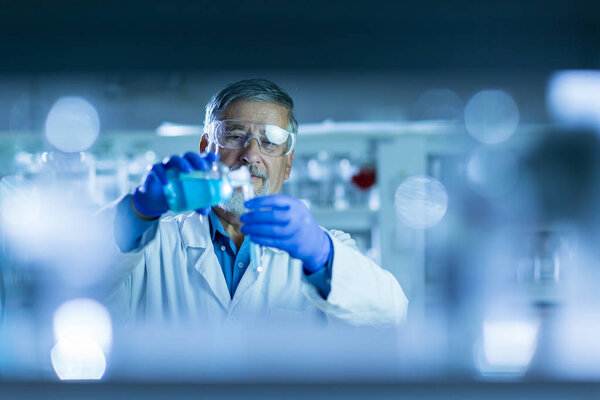 Senior male researcher carrying out scientific research in a lab