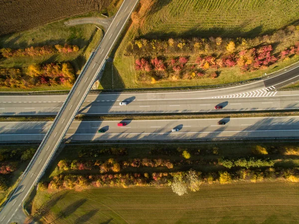 Aerial view of a highway amid fields with cars on it — Stock Photo, Image