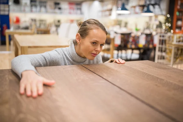 Woman choosing the right furniture — Stock Photo, Image