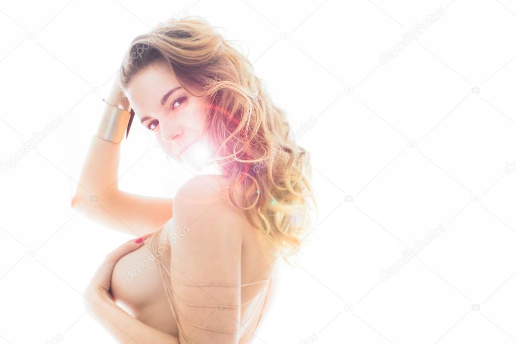 Gorgeous brunette young woman posing in strong backlight