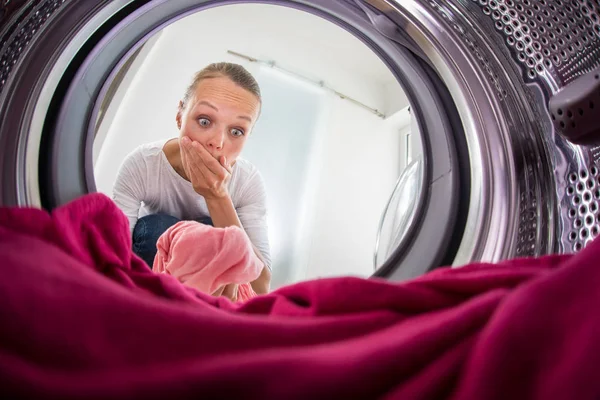 Young woman doing laundry - view from the washing machine — Stock Photo, Image