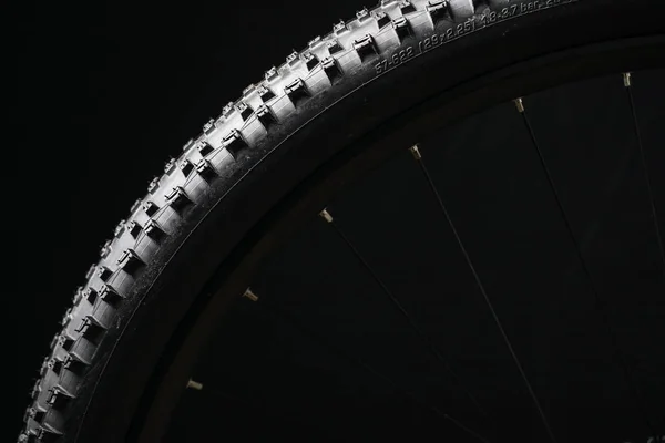 Modern MTB race mountain bike tyre isolated on black background — Stock Photo, Image