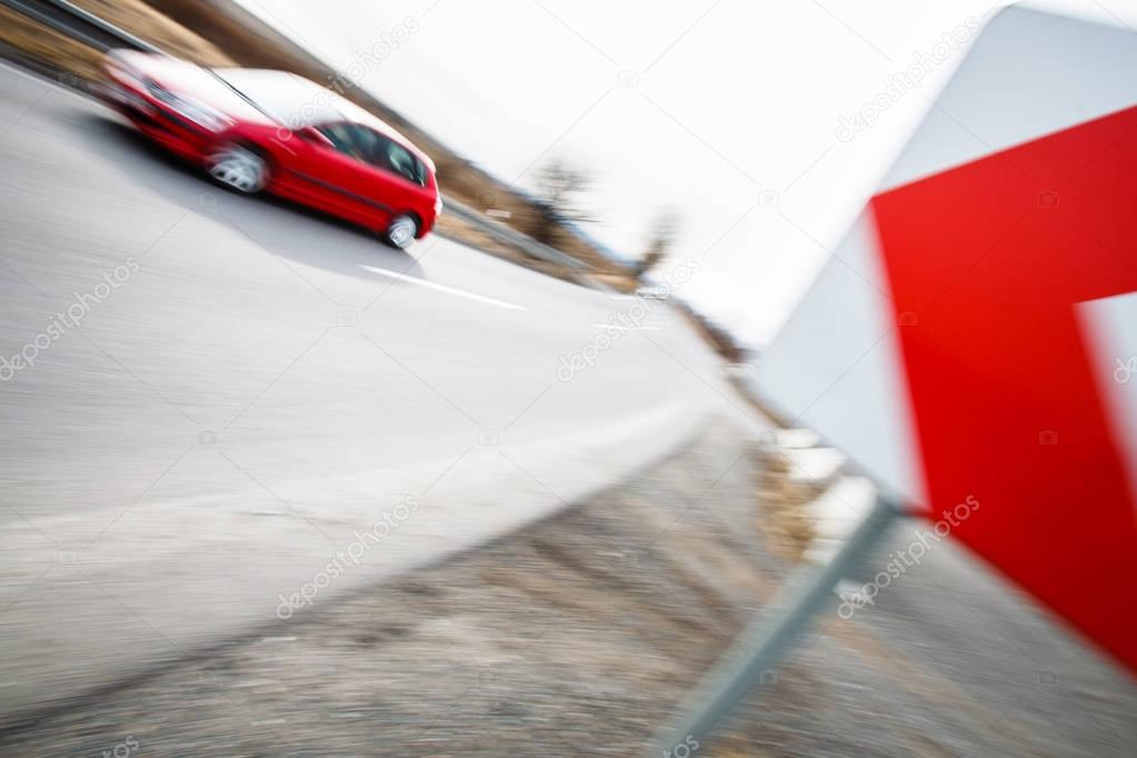 Traffic concept: car driving fast through a sharp turn (motion b