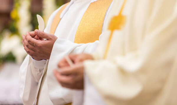 Priest' hands during a wedding ceremony/nuptial mass