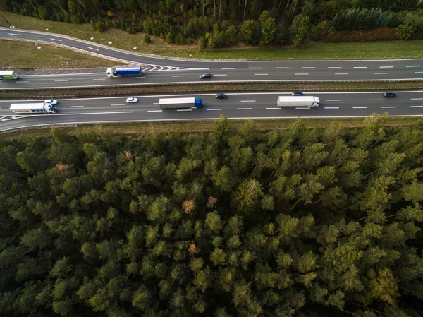 Aerial view of a highway amid fields with cars on it — Stock Photo, Image