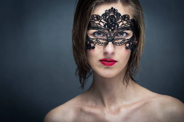 Attractive young woman with mask (color toned image) — Stock Photo, Image