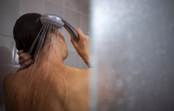 Hezká, mladá žena dává dlouhou horkou sprchu mytí vlasů — Stock fotografie