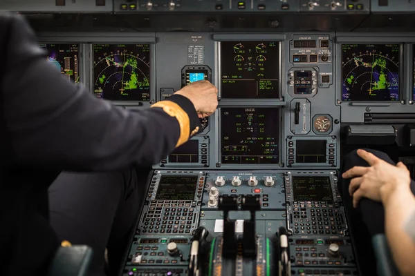 Pilot's hand dialing in flight values — 스톡 사진