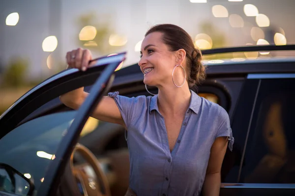 Pretty, young woman  driving a car