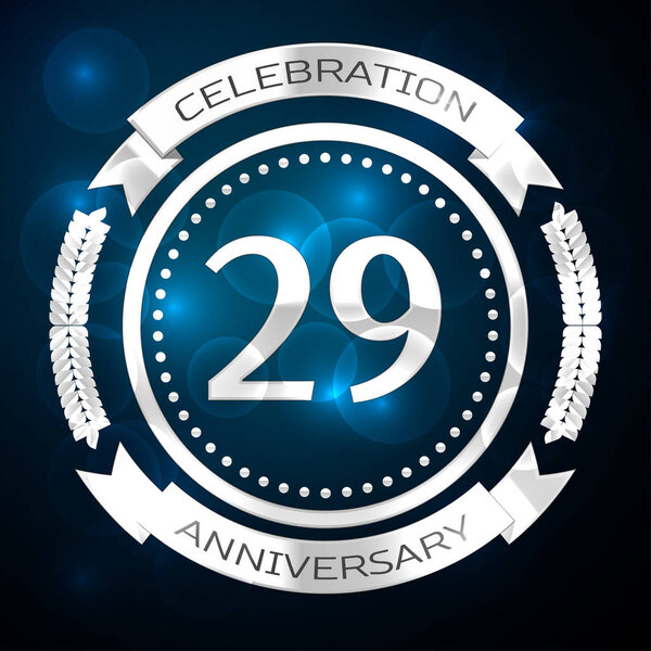 Twenty nine years anniversary celebration with silver ring and ribbon on blue background. Vector illustration