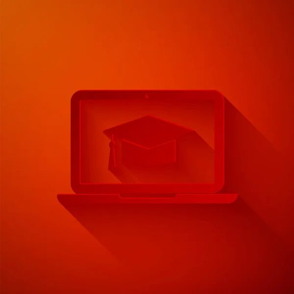 Paper cut Graduation cap on screen laptop icon isolated on red background. Online learning or e-learning concept. Paper art style. Vector Illustration — Stock Vector