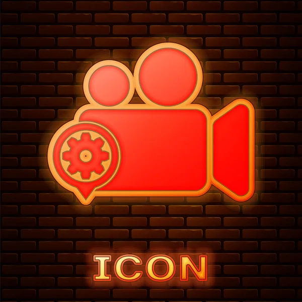 Glowing neon Movie or Video camera and gear icon isolated on brick wall background. Adjusting app, service concept, setting options, maintenance, repair, fixing. Vector Illustration — Stock Vector