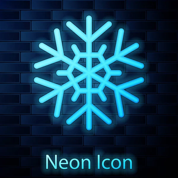 Ícone de floco de neve de néon brilhante isolado no fundo da parede de tijolo. Ilustração vetorial — Vetor de Stock