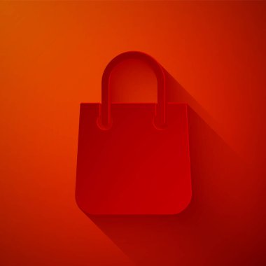 Kırmızı arkaplanda kağıt kesikli alışveriş poşeti simgesi izole edildi. Paket işareti. Kağıt sanatı tarzı. Vektör İllüstrasyonu