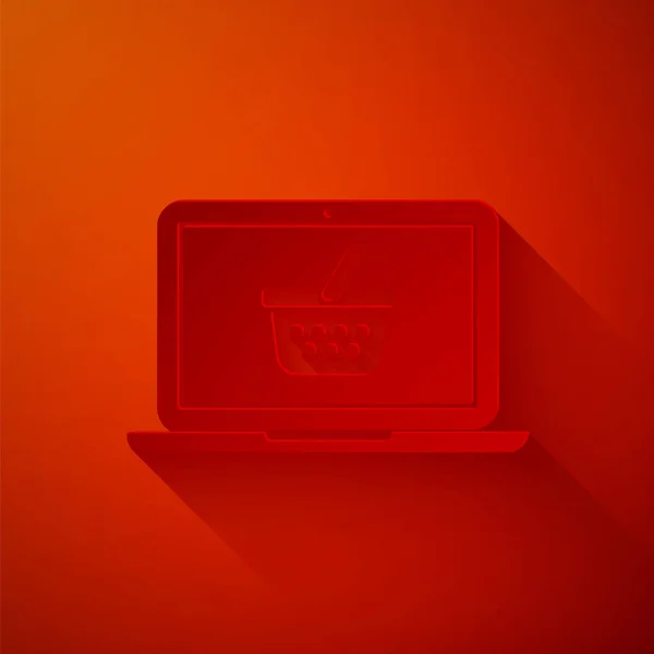 Carta tagliata Carrello sullo schermo icona del computer portatile isolato su sfondo rosso. Concetto e-commerce, e-business, marketing aziendale online. Stile cartaceo. Illustrazione vettoriale — Vettoriale Stock