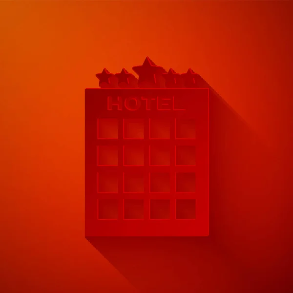 Paper cut Hotel building icon isolated on red background. Paper art style. Vector Illustration — Stock Vector