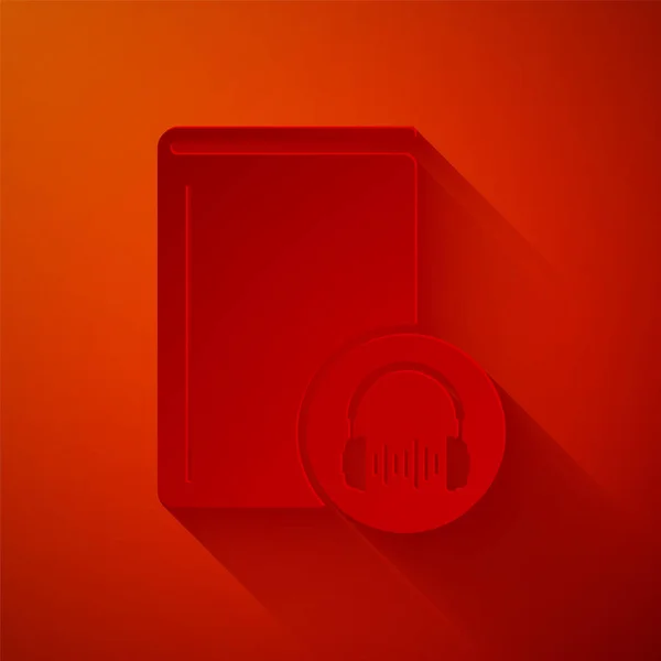 Carta tagliata Icona audiolibro isolata su sfondo rosso. Prenota con le cuffie. Segnale audio guida. Concetto di apprendimento online. Stile cartaceo. Illustrazione vettoriale — Vettoriale Stock