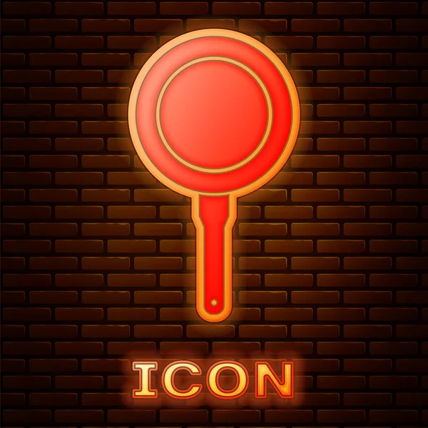 Glowing neon Frying pan icon isolated on brick wall background. Fry or roast food symbol. Vector Illustration — Stock Vector
