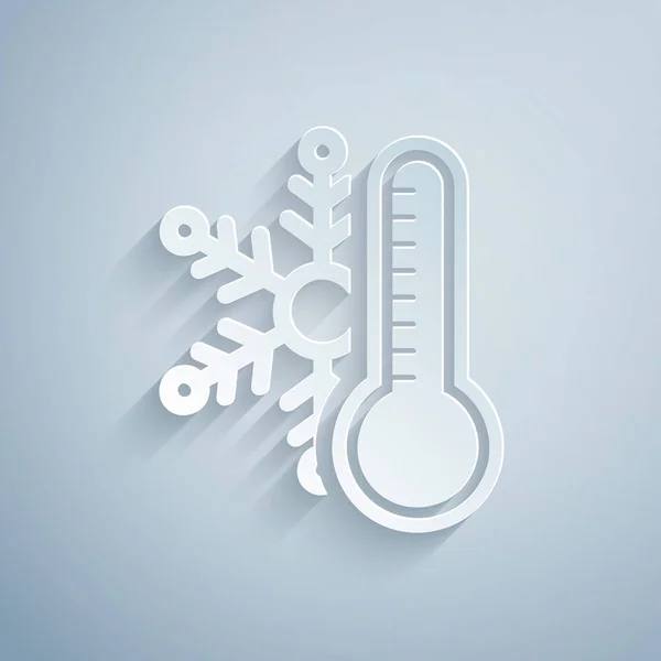 Paper cut Thermometer with snowflake icon isolated on grey background. Paper art style. Vector Illustration — Stock Vector