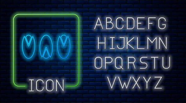 Gloeiende neon Pistachio noten pictogram geïsoleerd op baksteen muur achtergrond. Neon licht alfabet. Vector Illustratie — Stockvector