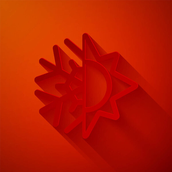 Paper cut Hot and cold symbol. Sun and snowflake icon isolated on red background. Winter and summer symbol. Paper art style. Vector Illustration