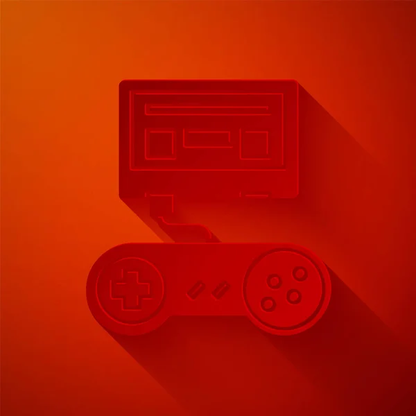 Corte de papel Console de videogame com ícone de joystick isolado no fundo vermelho. Estilo de arte de papel. Ilustração vetorial — Vetor de Stock