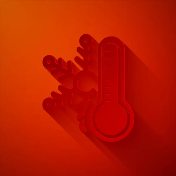 Паперовий виріз Термометр з піктограмою сніжинки ізольовано на червоному тлі. Стиль паперового мистецтва. Векторна ілюстрація — стоковий вектор