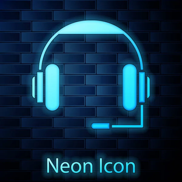 Zářící neonové sluchátka ikona izolované na cihlové zdi pozadí. Sluchátka. Koncepce poslechu hudby, služeb, komunikace a operátora. Vektorová ilustrace — Stockový vektor